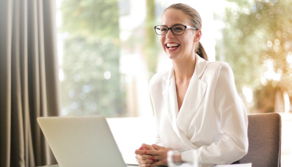 A happy business woman excited about business processes.