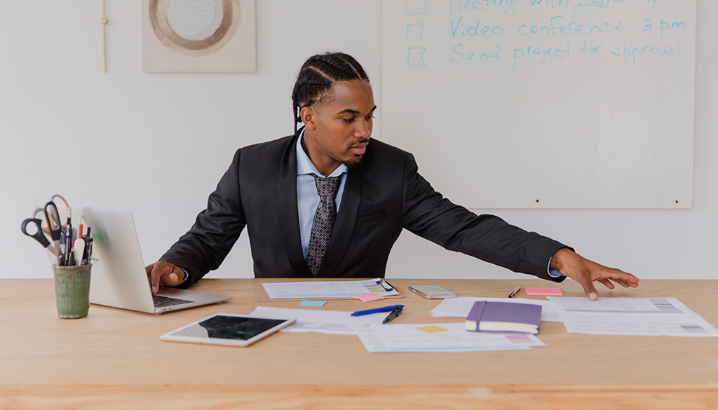 A businessman organizing papers on a desk.