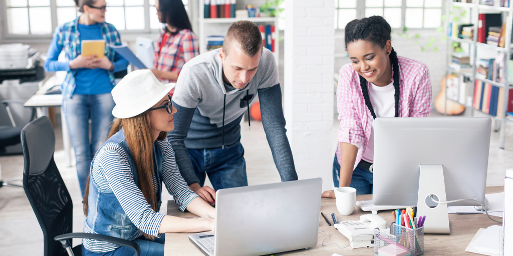 Co workers collaborating to leverage workplace automation.